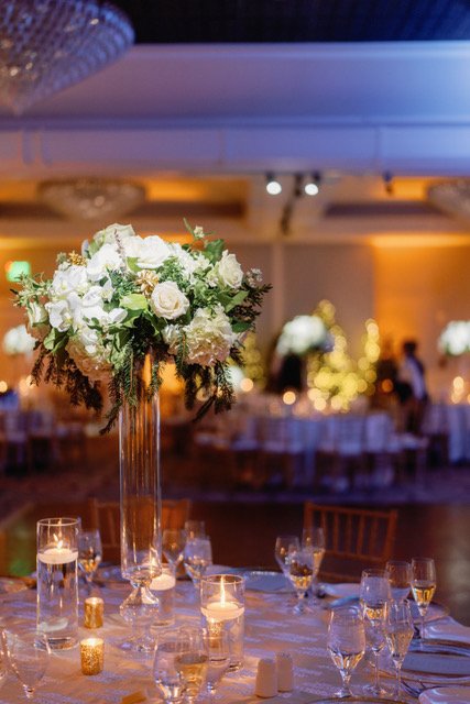 Tall white and green centerpiece in a ballroom